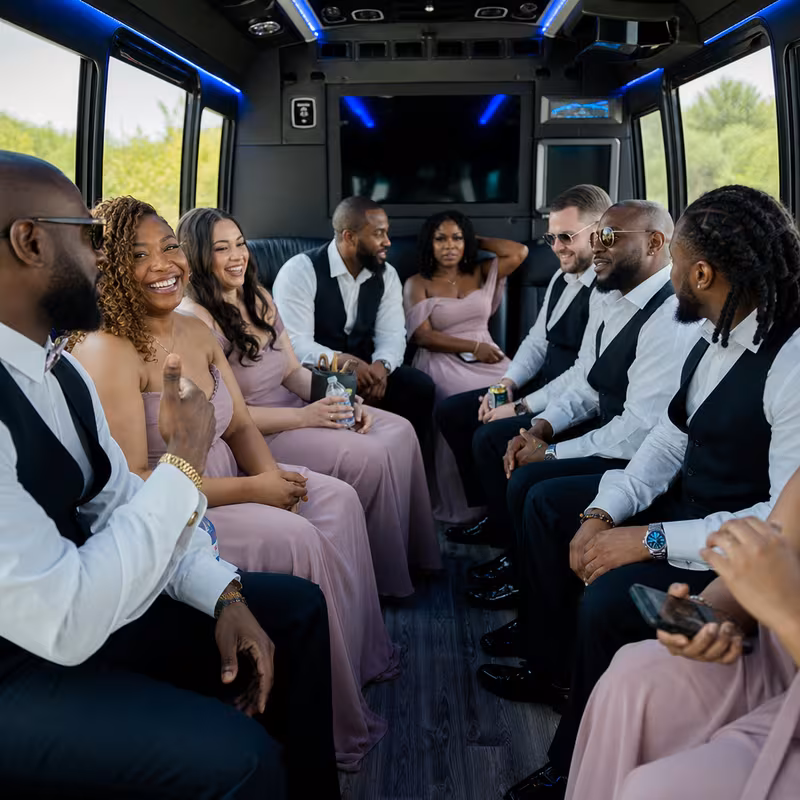 Wedding guests seated inside a Kansas City party bus