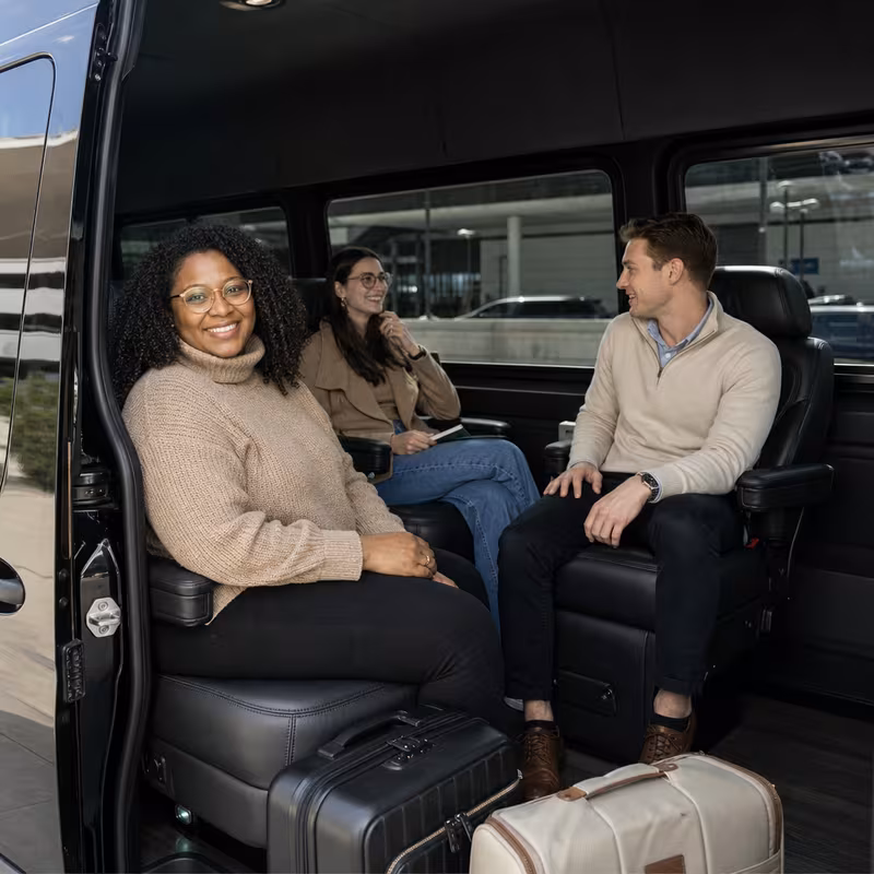 Passengers loading luggage while boarding an Kansas City group shuttle