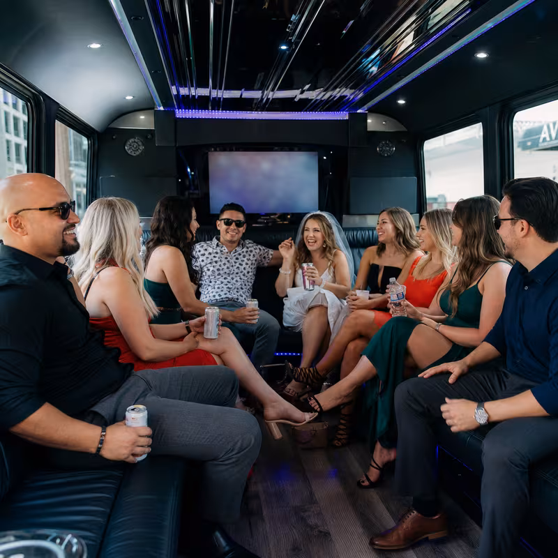 Party bus interior with wraparound leather seating and LED lighting in Kansas City