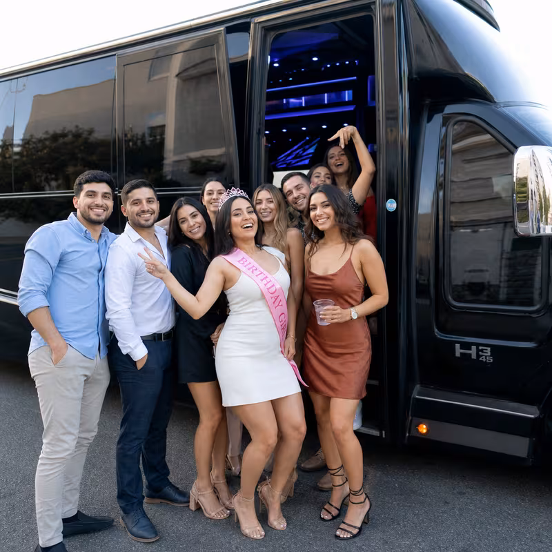 Group boarding a white charter bus for Birthday Transportation transportation in Kansas City