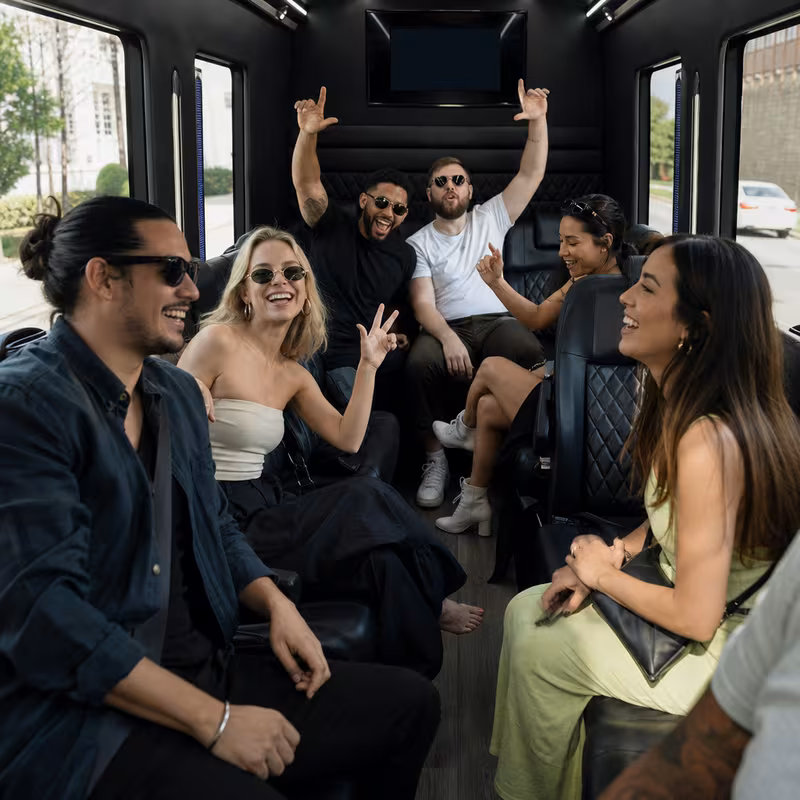 Group boarding a white charter bus for Concert Transportation transportation in Kansas City