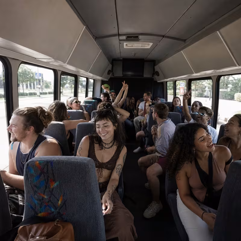 Party bus interior with wraparound leather seating and LED lighting in Kansas City