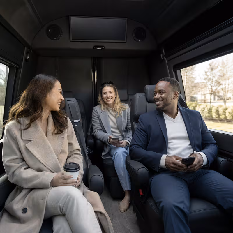 Group boarding a white charter bus for Corporate Transportation transportation in Kansas City