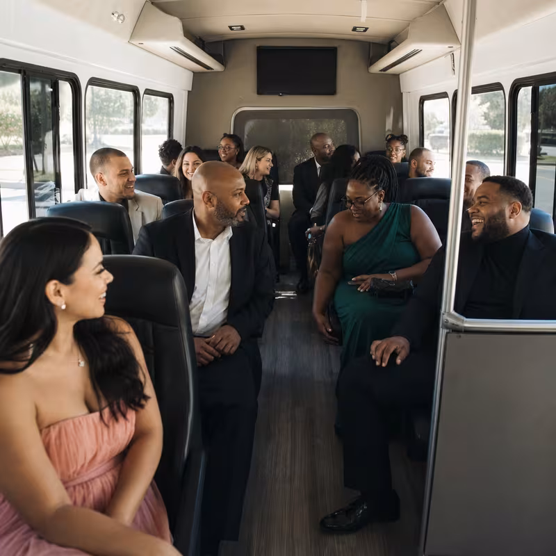 Group boarding a white charter bus for Private Event Transportation transportation in Kansas City