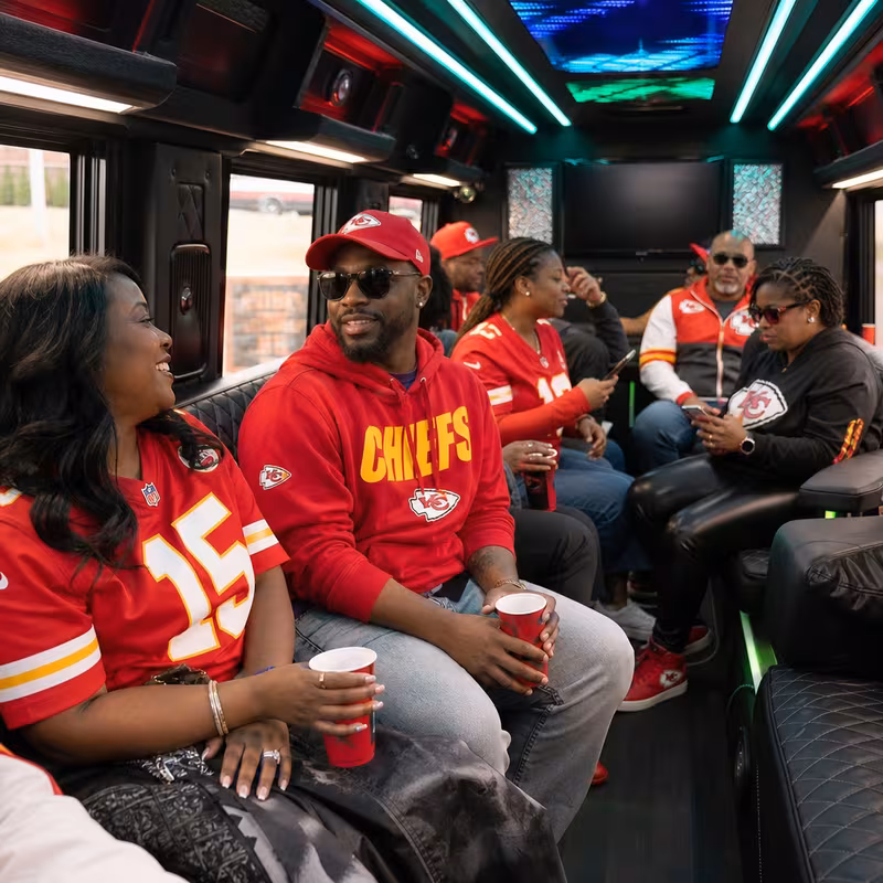 Group boarding a white charter bus for Sporting Event Transportation transportation in Kansas City