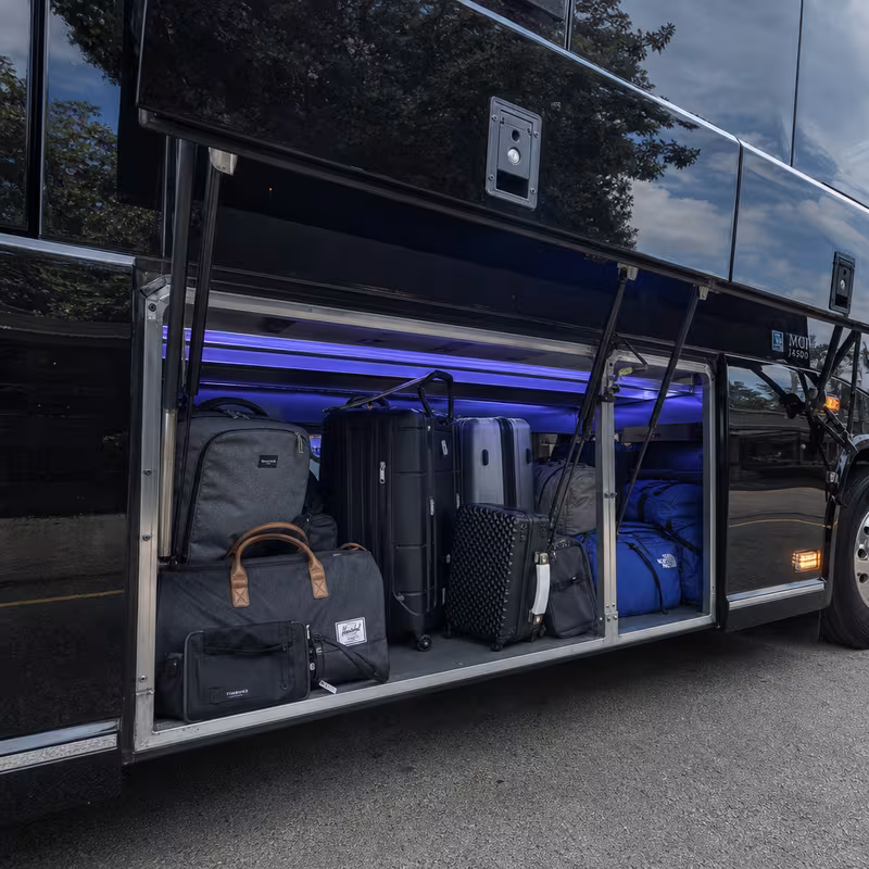 Party bus interior with wraparound leather seating and LED lighting in Kansas City