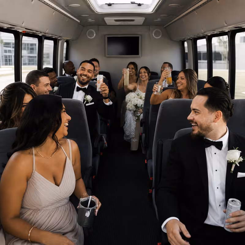 Group boarding a white charter bus for Wedding Transportation transportation in Kansas City