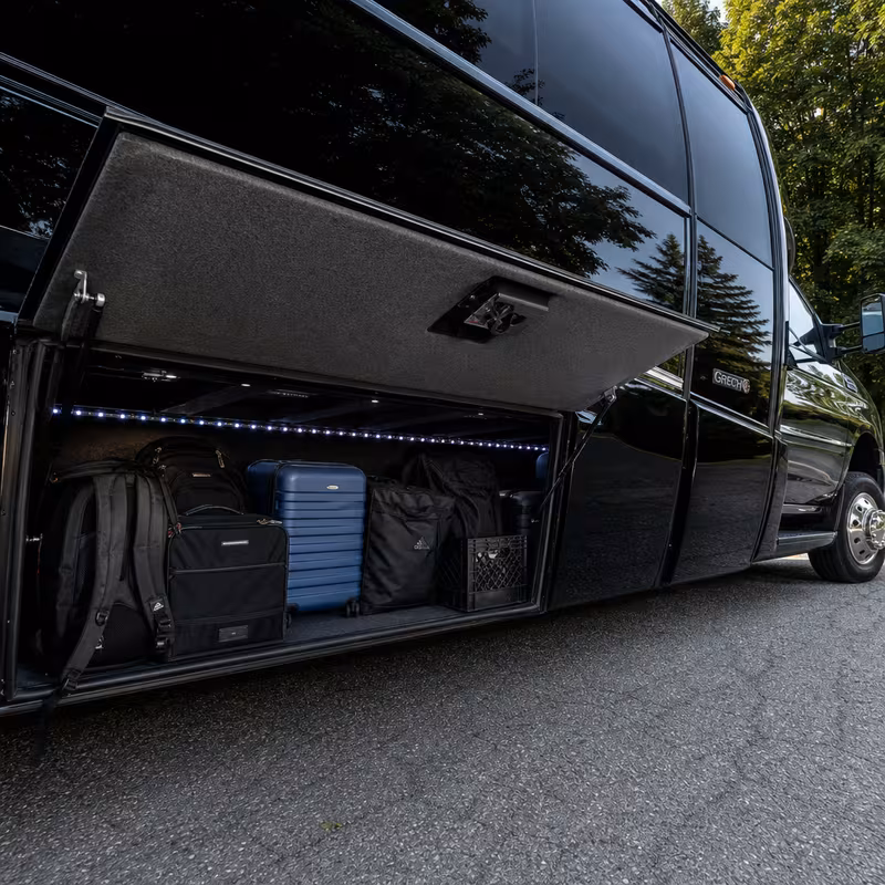 Party bus interior with wraparound leather seating and LED lighting in Kansas City