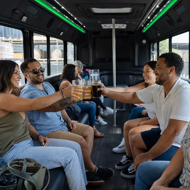 Group boarding a white charter bus for Winery & Brewery Tour Transportation transportation in Kansas City