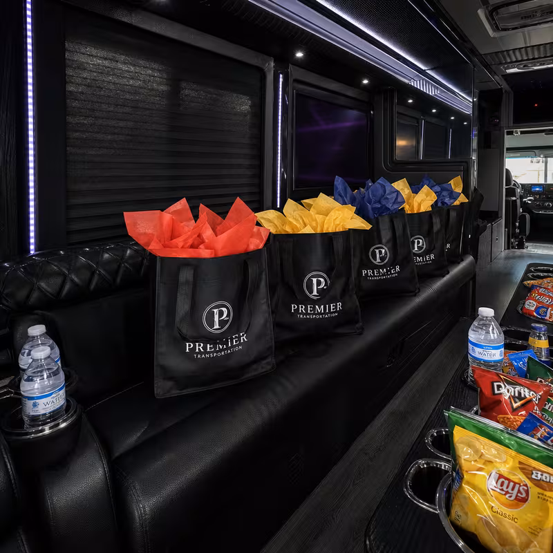 Party bus interior with wraparound leather seating and LED lighting in Kansas City